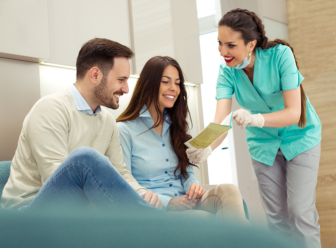 dentist showing patient paperwork